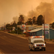 An ambulance from the towns of Heber and Overgaard on June 24, 2002 in Show Low, Arizona as smoke envelops the evacuated town during a wildfire.